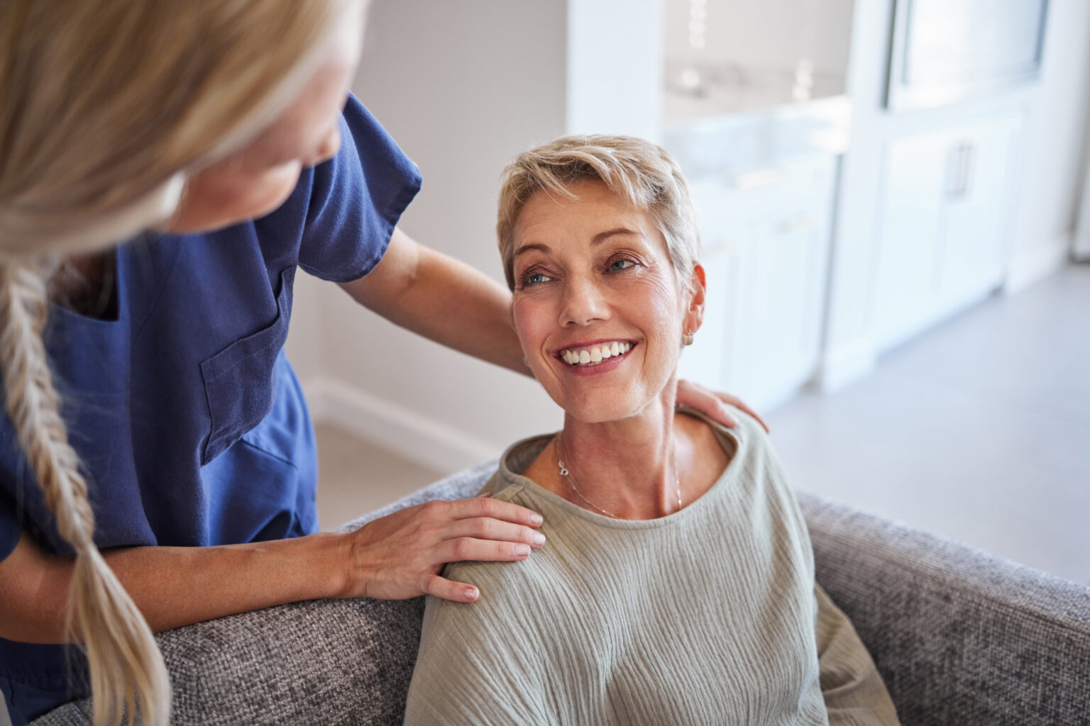 Attractive senior woman, patient talking to cosmetologist doctor, he touches her face, lifting, botox, rejuvenation. Skin care concept, cosmetic procedure