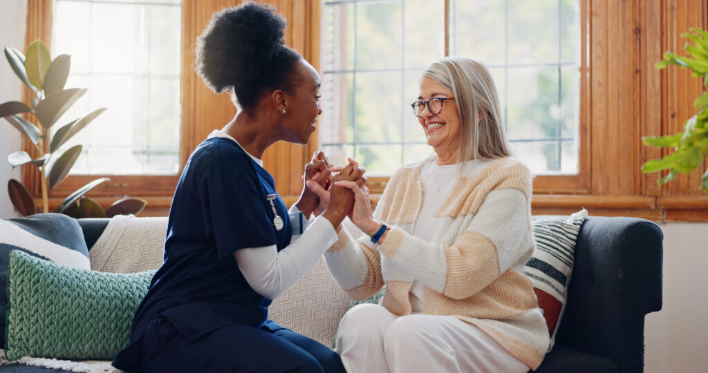 Senior patient, funny or happy caregiver talking for healthcare support at nursing home clinic. Smile, women laughing or nurse speaking of joke to a mature person or woman in a friendly conversation